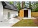 Backyard featuring a shed with open doors, a concrete patio, and well-maintained lawn at 2263 Barge Rd, Atlanta, GA 30331