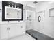 Modern bathroom featuring a glass-enclosed shower, dual vanity, and illuminated mirrors at 2263 Barge Rd, Atlanta, GA 30331