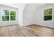 Bright bedroom featuring hardwood floors and natural light from two large windows at 2263 Barge Rd, Atlanta, GA 30331