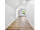 Bright hallway with hardwood floors, white walls, and natural light from a window at the end at 2263 Barge Rd, Atlanta, GA 30331