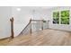 Upstairs hallway featuring an ornate railing and a large window at 2263 Barge Rd, Atlanta, GA 30331
