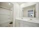 Bright bathroom features a double sink vanity and shower over tub with white wall tiles at 2804 Torunn Ct, Atlanta, GA 30331