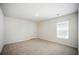 This bedroom features neutral carpet and a window that provides natural light at 2804 Torunn Ct, Atlanta, GA 30331