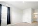 Cozy bedroom featuring carpet, a window with dark curtains, and a door to an attached bathroom at 2804 Torunn Ct, Atlanta, GA 30331