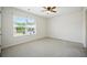 This bedroom features neutral carpet and a large window that provides natural light at 2804 Torunn Ct, Atlanta, GA 30331