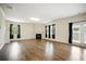 Open living room featuring hardwood flooring, a fireplace, white trim, and a sliding door at 2804 Torunn Ct, Atlanta, GA 30331