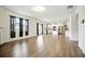 Open living space with hardwood floors leading to the kitchen with white cabinetry and island at 2804 Torunn Ct, Atlanta, GA 30331
