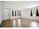 Bright, open living room with hardwood floors, three large windows, and white trim at 2804 Torunn Ct, Atlanta, GA 30331