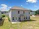 A well maintained backyard and rear facade of a two-story home under a blue, partly cloudy sky at 3360 Meadow Grass Dr, Dacula, GA 30019