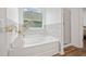 Bright bathroom features a bathtub and a walk-in shower next to each other at 3360 Meadow Grass Dr, Dacula, GA 30019