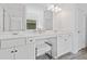 Bright bathroom features a double vanity, lots of counter space, and a makeup vanity space with stool at 3360 Meadow Grass Dr, Dacula, GA 30019