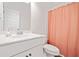 Bathroom features a white sink, a toilet, and a shower with an orange shower curtain at 3360 Meadow Grass Dr, Dacula, GA 30019