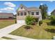 Beautiful two-story home boasts a well-maintained lawn, a two-car garage, and classic architectural details at 3360 Meadow Grass Dr, Dacula, GA 30019