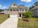 Charming two-story home featuring a brick and siding facade, a well-manicured lawn, and a two-car garage at 3360 Meadow Grass Dr, Dacula, GA 30019