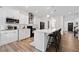 Bright, modern kitchen featuring white cabinetry, stainless steel appliances, and a spacious island with seating at 3360 Meadow Grass Dr, Dacula, GA 30019