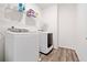 Bright laundry room with a new washer and dryer on wood-look floors at 3360 Meadow Grass Dr, Dacula, GA 30019