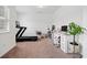 Home office space with a treadmill, multiple desks, carpet, and bright natural light at 3360 Meadow Grass Dr, Dacula, GA 30019