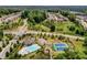 An aerial view of a community pool and tennis courts nestled among lush greenery and houses at 6110 Read Rd, Suwanee, GA 30024