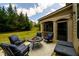 Beautiful backyard with a covered patio seating area with dark blue cushions at 6110 Read Rd, Suwanee, GA 30024