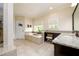 Spacious bathroom featuring a soaking tub, granite counters, tile floors, and natural light at 6110 Read Rd, Suwanee, GA 30024