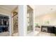 Bright bathroom featuring a large shower, walk-in closet and a vanity with dark cabinets at 6110 Read Rd, Suwanee, GA 30024