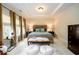 Bright bedroom with a tray ceiling and neutral colored walls at 6110 Read Rd, Suwanee, GA 30024