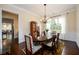 Formal dining room features dark wood table, upholstered chairs, and elegant chandelier at 6110 Read Rd, Suwanee, GA 30024