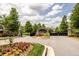 Stone entrance to The Reserve neighborhood with mature landscaping and trees at 6110 Read Rd, Suwanee, GA 30024