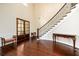 Grand foyer featuring dark wood floors, staircase with iron railings, and wainscoting at 6110 Read Rd, Suwanee, GA 30024