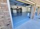 Spacious three-car garage featuring epoxy flooring and ample storage cabinets at 6110 Read Rd, Suwanee, GA 30024