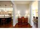 Hallway view of the Kitchen and Dining Room in this home with stained hardwood flooring at 6110 Read Rd, Suwanee, GA 30024