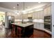 Bright kitchen features granite countertops, a center island, and stainless steel appliances at 6110 Read Rd, Suwanee, GA 30024
