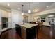 Open kitchen with center island, stainless steel appliances, double oven, and an adjacent living area at 6110 Read Rd, Suwanee, GA 30024