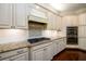 Well-lit kitchen features granite countertops, a gas range, and stainless steel double ovens at 6110 Read Rd, Suwanee, GA 30024