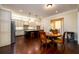 Eat-in kitchen features a wine fridge, stainless steel appliances, and a center island with bar stool seating at 6110 Read Rd, Suwanee, GA 30024
