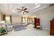 Bright living room featuring a decorative ceiling, ceiling fan, a comfortable sectional and lots of natural light at 6110 Read Rd, Suwanee, GA 30024