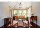 Bright sitting room with a vaulted ceiling, three large windows, and hardwood floors at 6110 Read Rd, Suwanee, GA 30024