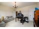 Bright office space with neutral walls, multiple doorways, couch, chandelier, and large desk at 6110 Read Rd, Suwanee, GA 30024