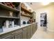 Butler's pantry area featuring custom cabinets and shelving, countertop workspace and beverage area at 6110 Read Rd, Suwanee, GA 30024