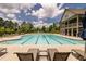 Community pool featuring lounge chairs and a beautiful clubhouse at 6110 Read Rd, Suwanee, GA 30024