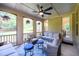 Inviting porch with cushioned seating, side tables, and a ceiling fan at 6110 Read Rd, Suwanee, GA 30024