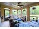 Inviting sunroom with ample seating, ceiling fan, and views of the landscaped backyard at 6110 Read Rd, Suwanee, GA 30024