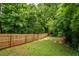 Large backyard featuring a well maintained lawn surrounded by a wooden fence and lots of lush greenery at 23 Clifton Se St, Atlanta, GA 30317