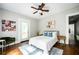 Bright bedroom with stylish decor, ceiling fan, and door leading to outdoor deck at 23 Clifton Se St, Atlanta, GA 30317