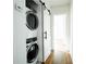 Hallway laundry closet with stackable washer and dryer units behind a sliding door at 23 Clifton Se St, Atlanta, GA 30317