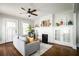 Inviting living room featuring hardwood floors, a stylish ceiling fan, and a charming fireplace at 23 Clifton Se St, Atlanta, GA 30317