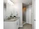 Elegant bathroom features a granite vanity, a well-lit mirror, and a glass-enclosed shower, combining functionality with refined style at 361 17Th Nw St # 1603, Atlanta, GA 30363