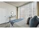 Sun-filled bedroom with a large window offering city views, complemented by neutral tones and stylish accents for a modern retreat at 361 17Th Nw St # 1603, Atlanta, GA 30363