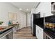 Modern kitchen with stainless steel appliances, granite countertops, and wood floors at 361 17Th Nw St # 1603, Atlanta, GA 30363