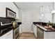 Modern kitchen with stainless steel appliances, sleek black backsplash, and granite countertops, exuding contemporary elegance at 361 17Th Nw St # 1603, Atlanta, GA 30363